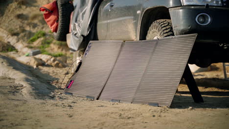 awd with portable solar photovoltaic panel camping on beach