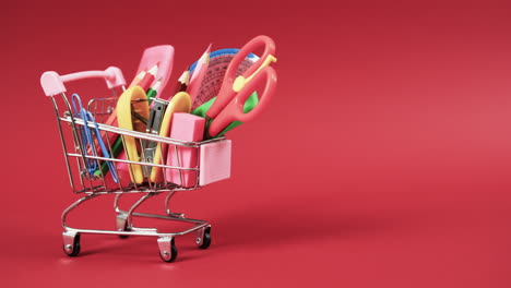 acercamiento del carrito de compras con artículos escolares con espacio de copia en fondo rojo