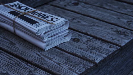 rolled up newspapers on a wooden bench