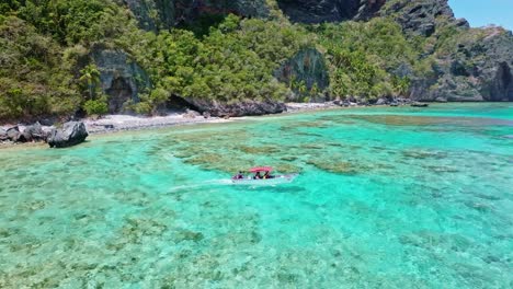 tourist boat sailing in transparent sea waters of playa fronton beach, samana in dominican republic