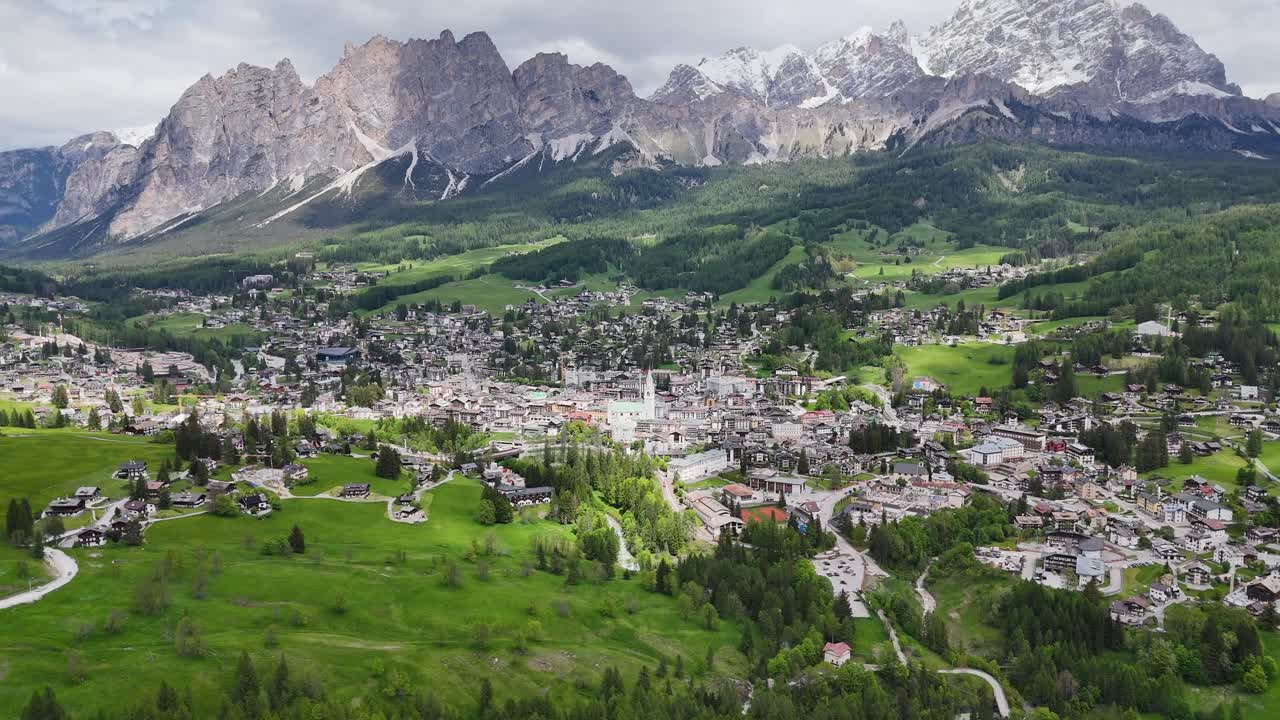 Drone circles Cortina d'Ampezzo, revealing Dolomites and Monte Cristallo.