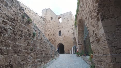 corridor coming from the kyrenia castle walls with view to ancient stone walls - wide gimbal push in shot