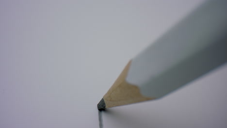 closeup wooden pencil writing flat line on white background in slow motion