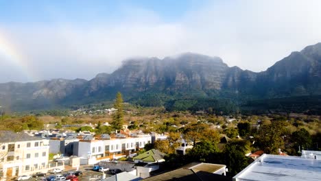 A-beautiful-rainbow-after-rain-on-a-misty-day-with-clouds-rolling-over-the-mountain