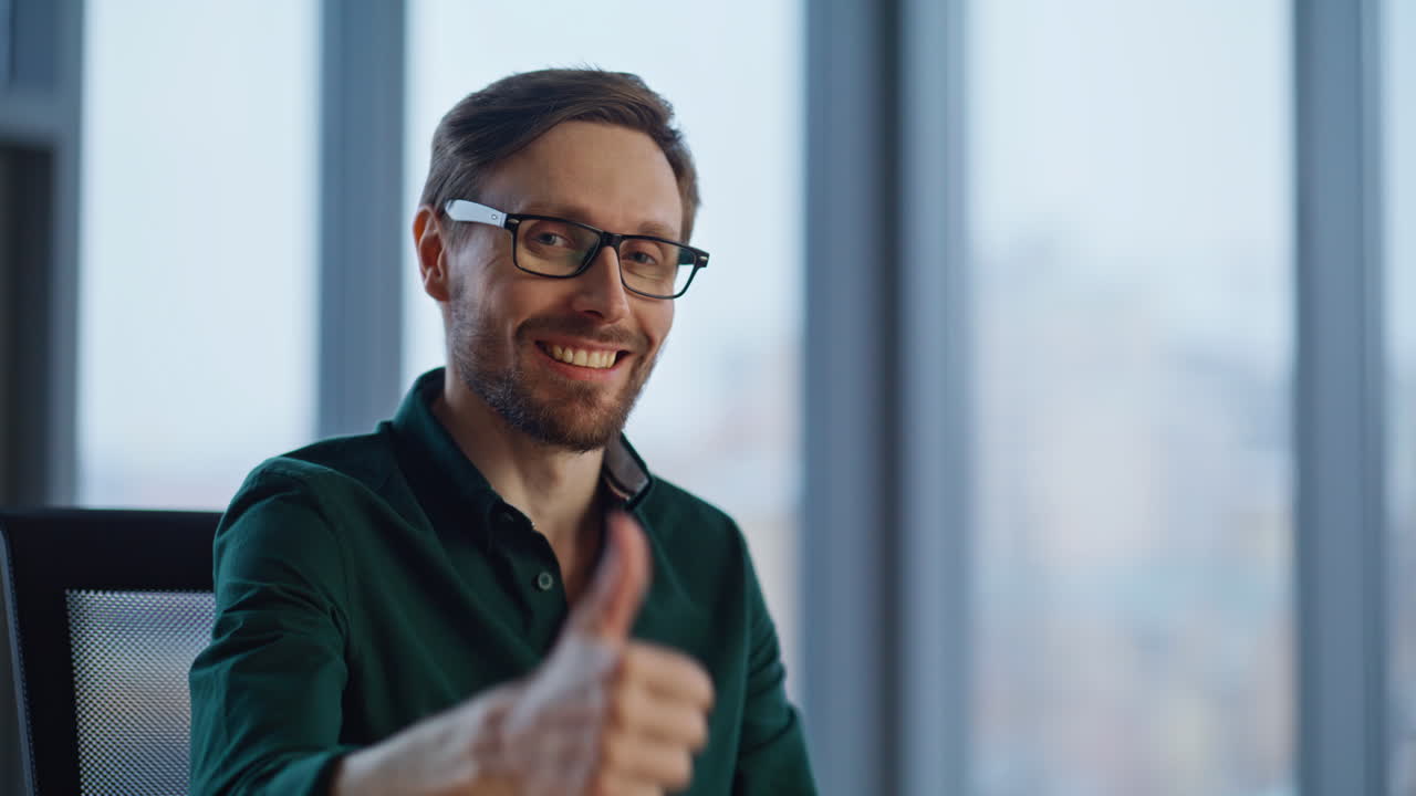 Smiling manager showing thumb up sitting modern corporate office space closeup