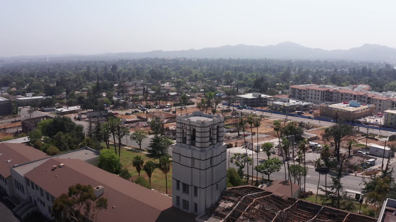 Close-up reverse pullback aerial shot of the Eliot Arts Magnet Academy on Lake Street after the Eaton Fire in Altadena, California. 4K