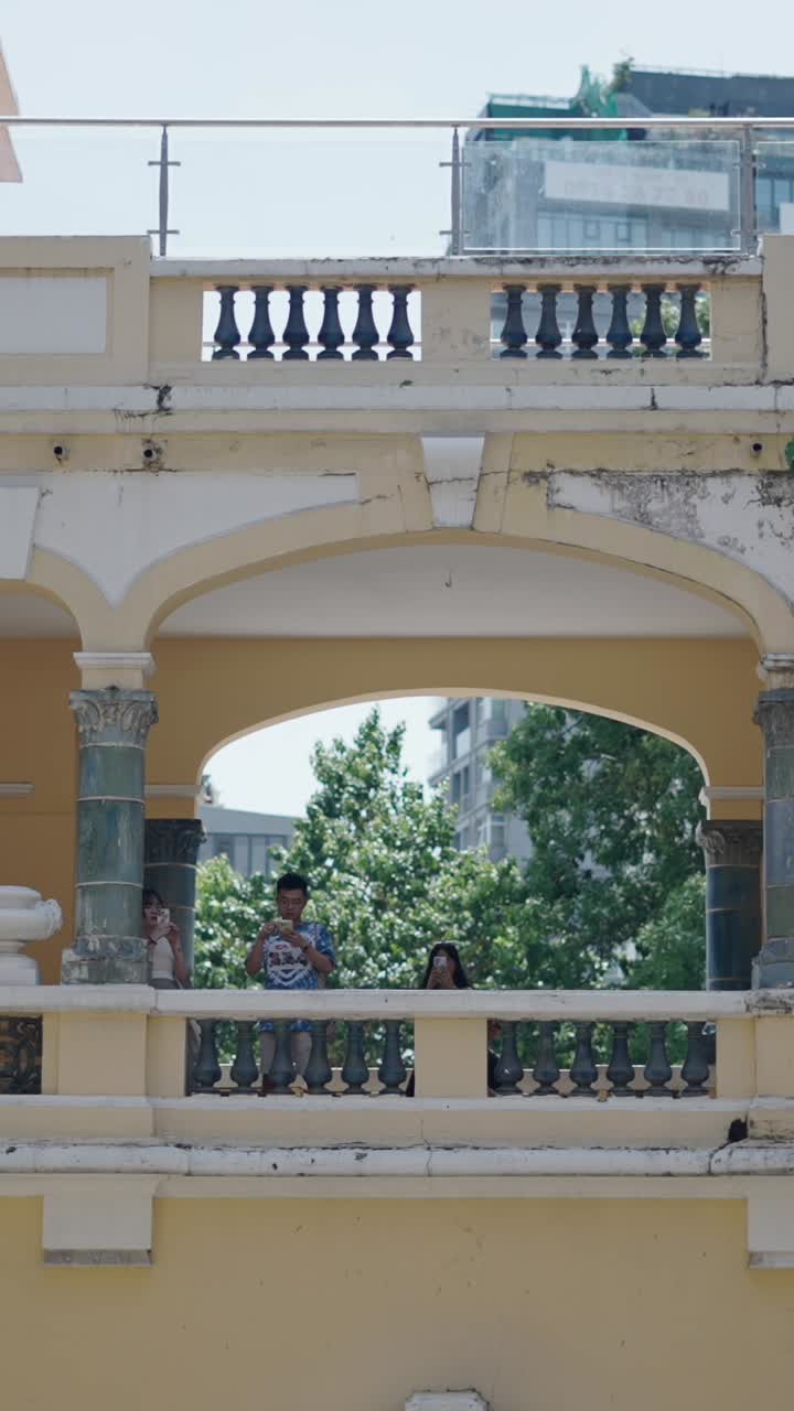 Building with Balcony and People