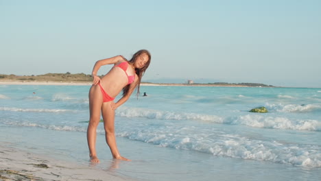 Pretty-woman-spending-holiday-at-beach.-Girl-doing-exercises-at-seaside.