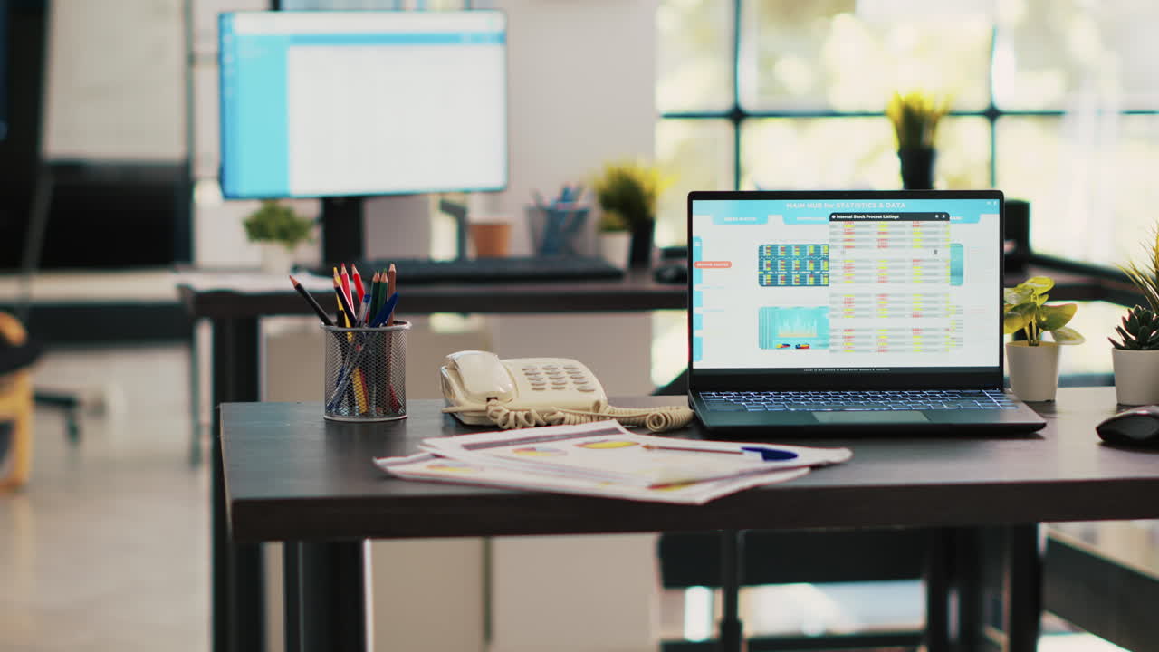 Stock market diagrams with charts and stock figures on laptop sitting on desk