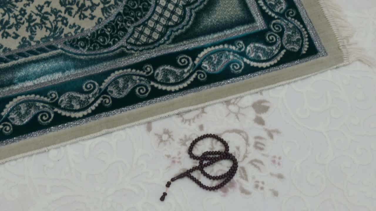 prayer rug laid to pray, green colored prayer and rosary, prayer rugs and rosary in Islam,