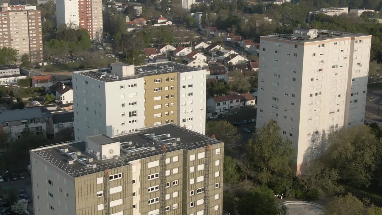 Drone footage provides an aerial view of a dense urban residential district with apartment blocks in Nantes. City living, neighborhood context. France
