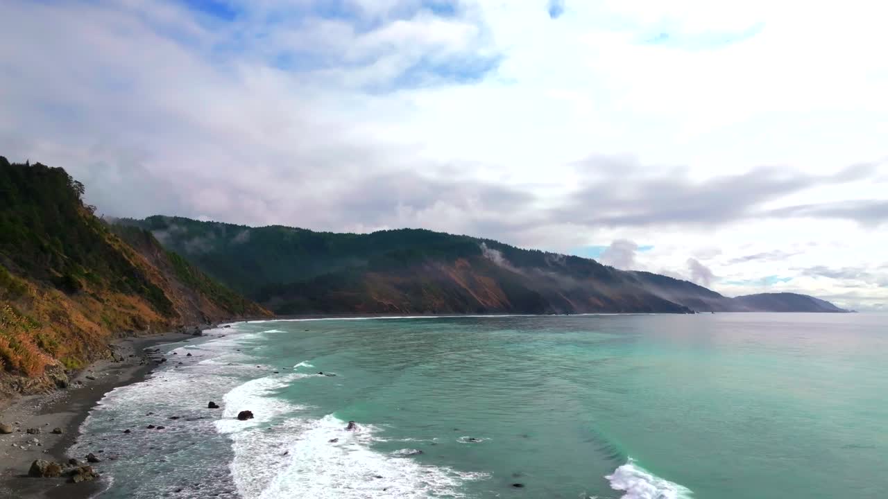 Waves Crashing black sand rugged coastline USAL Beach Campground Lost Coast Trail California blue sky sunny cloudy mist morning Pacific Ocean PNW Nor Cali boulders cliffs mountainside backwards motion