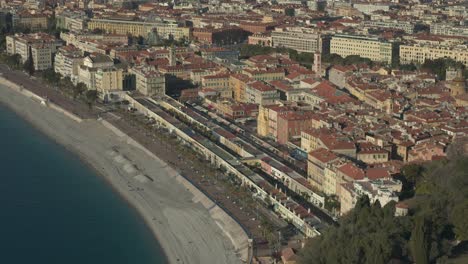 aerial view in french riviera with people on the beach in nice during summer day
long travelling drone shot in the french riviera during summer
lot of people on the beach and swimming
alongside forest