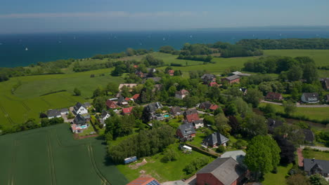 Dron-Aéreo-Que-Da-Vueltas-Alrededor-De-Los-Suburbios-Alberga-Una-Zona-Residencial-En-Brodten,-Alemania,-Mar-Báltico-De-Fondo,-Día