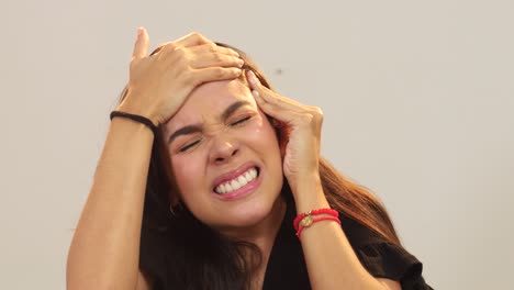 Close-up-of-young-woman-suffering-headache-and-holding-her-head