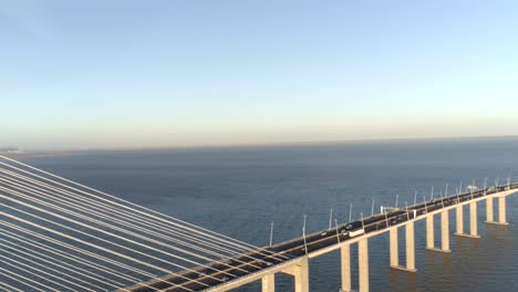 aerial drone video of ponte vasco da gama bridge with cars passing by