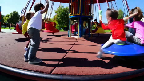 children enjoying a colorful playground carousel