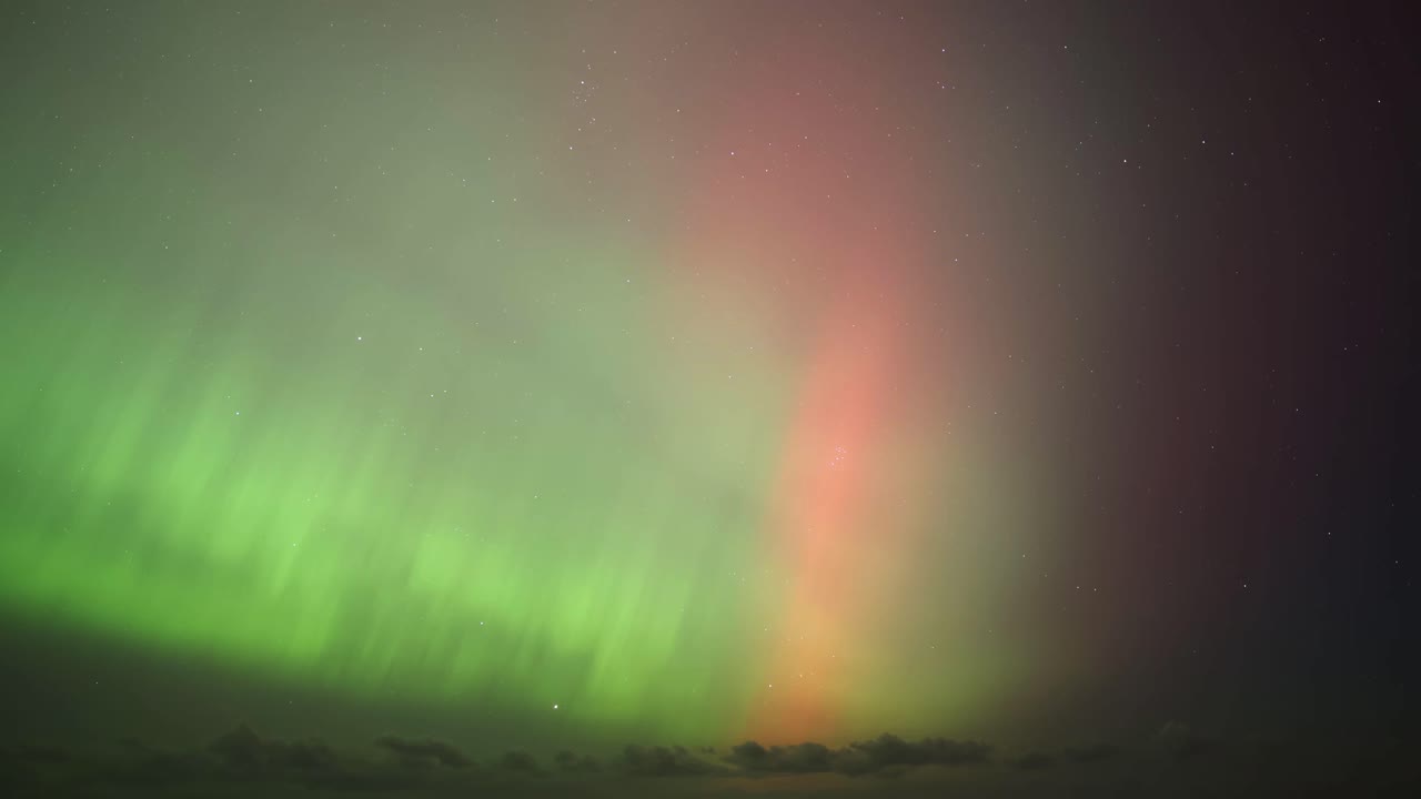 Timelapse shot of the northern lights bursting with energy over the UK coastline