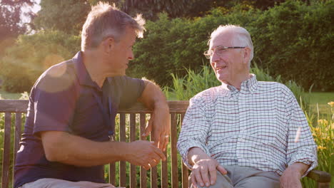 male nurse talking to senior man in residential care home