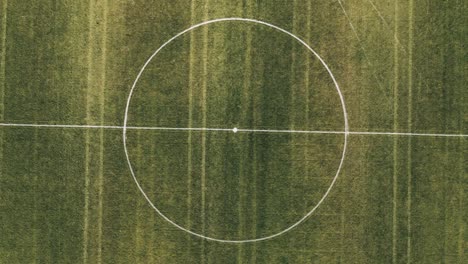 top view, aerial view of soccer field during sunset, aerial shot by drone