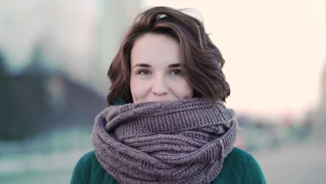 young woman wearing a scarf in the city