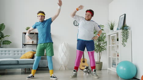 two men in 80s fitness attire doing funny stretches at home