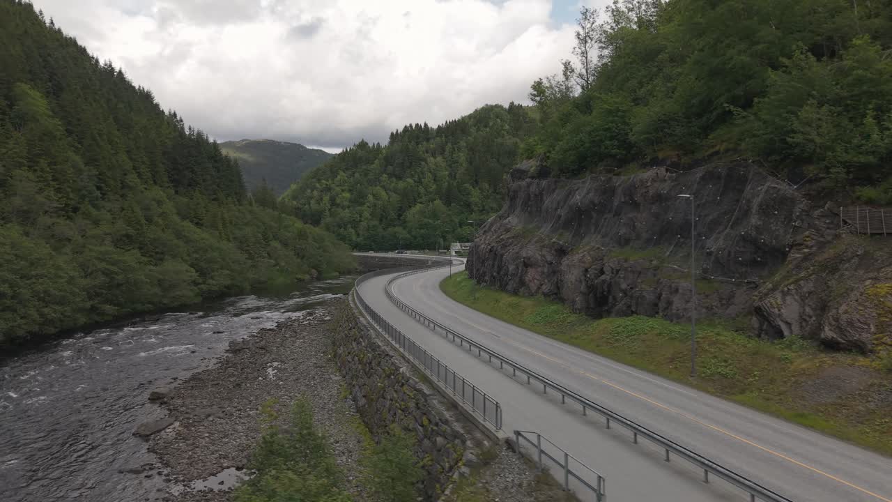 Winding Mountain Road River With Dense Forest. Aerial Drone Shot