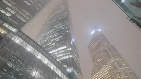 snowy night view of skyscrapers