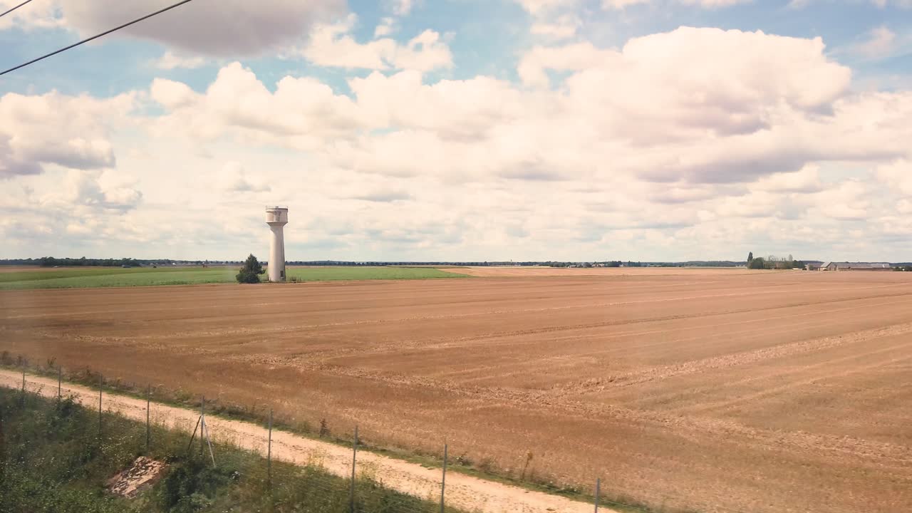 toma estática tomada desde el interior del tgv, el famoso tren rápido francés durante un día soleado, cruzando los campos en francia