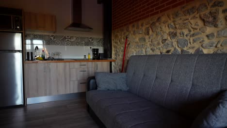cozy stone-walled kitchen and living area in a rustic home with modern appliances and furniture