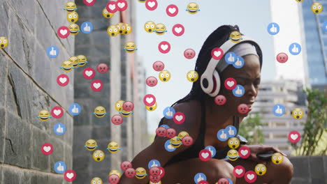 female athlete with headphones holding smartphone for marketing showcasing floating reaction emojis