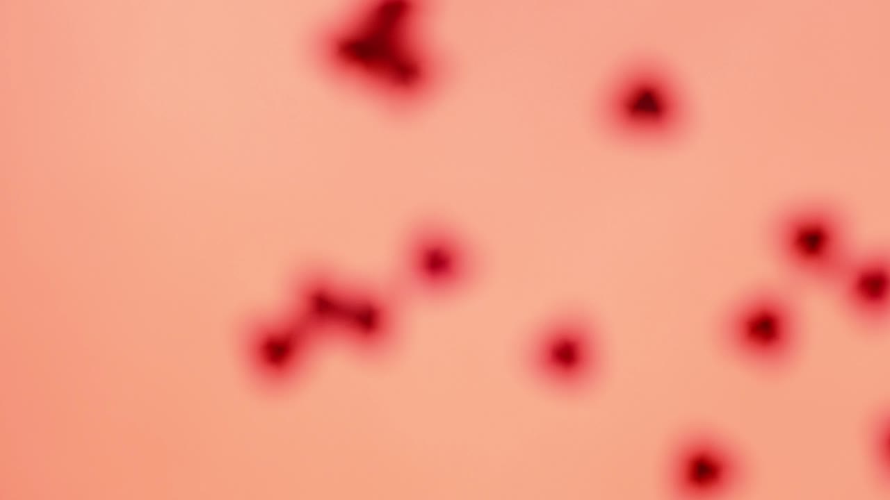 Red heart-shaped sequins are spinning in a circle on a red background