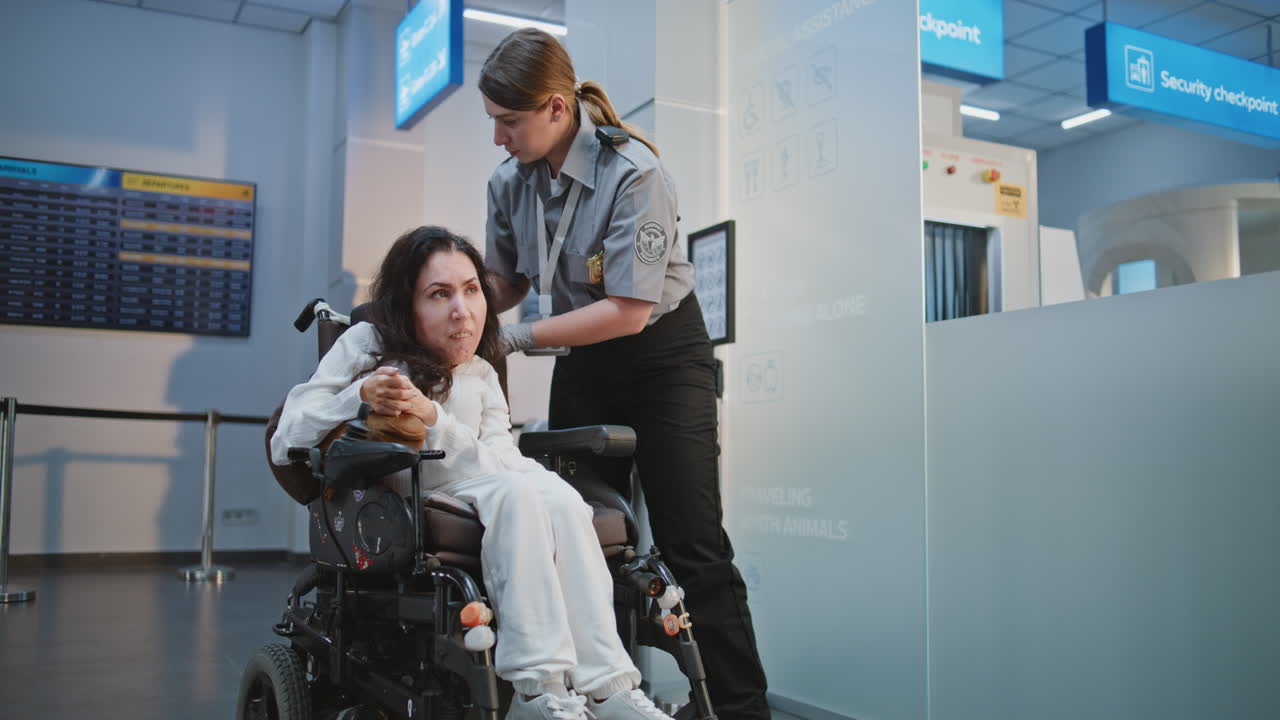 Airport Security Assisting a Passenger in a Wheelchair