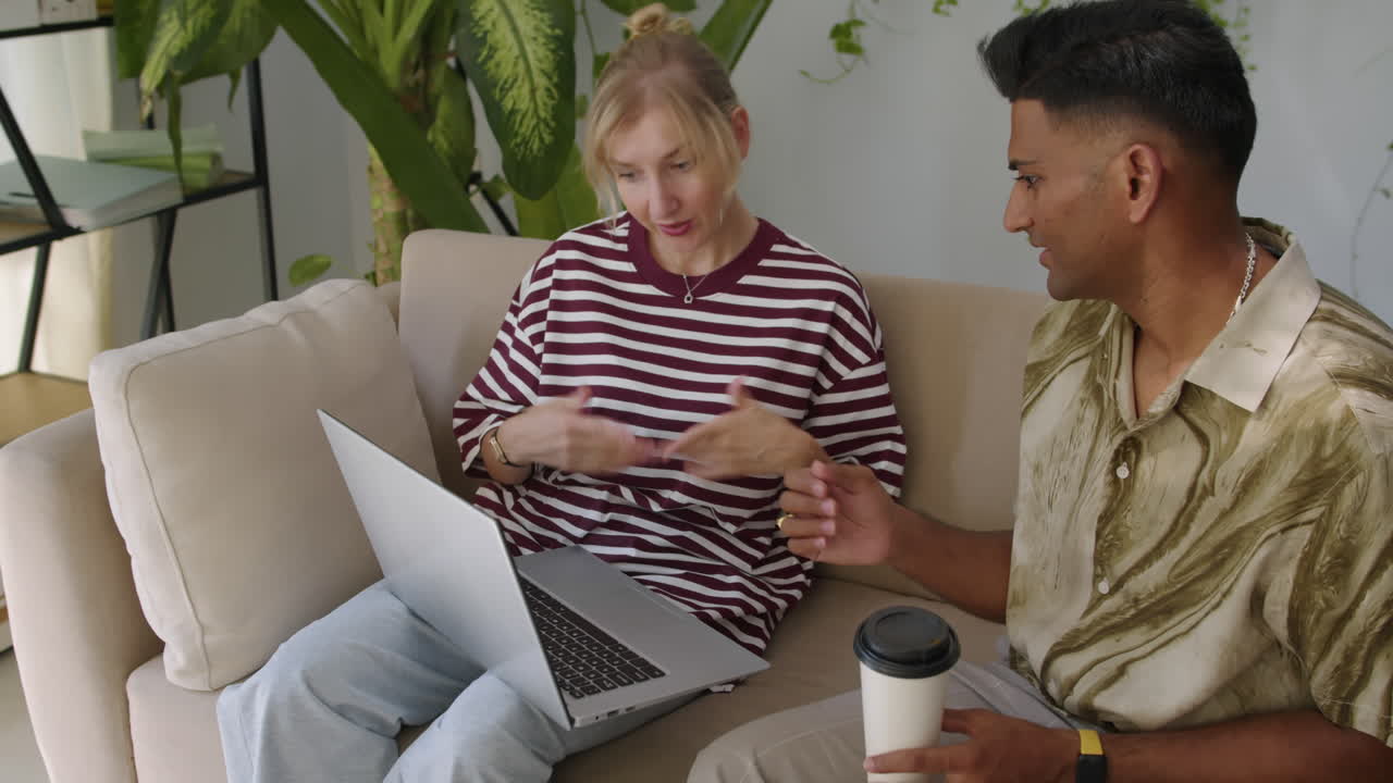 Intercultural Colleagues Discussing Business Using Laptop