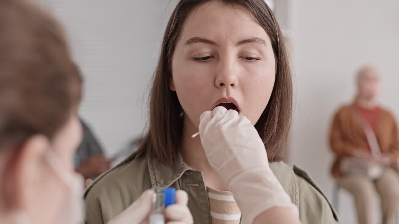 Young Woman Giving Saliva Sample Collected