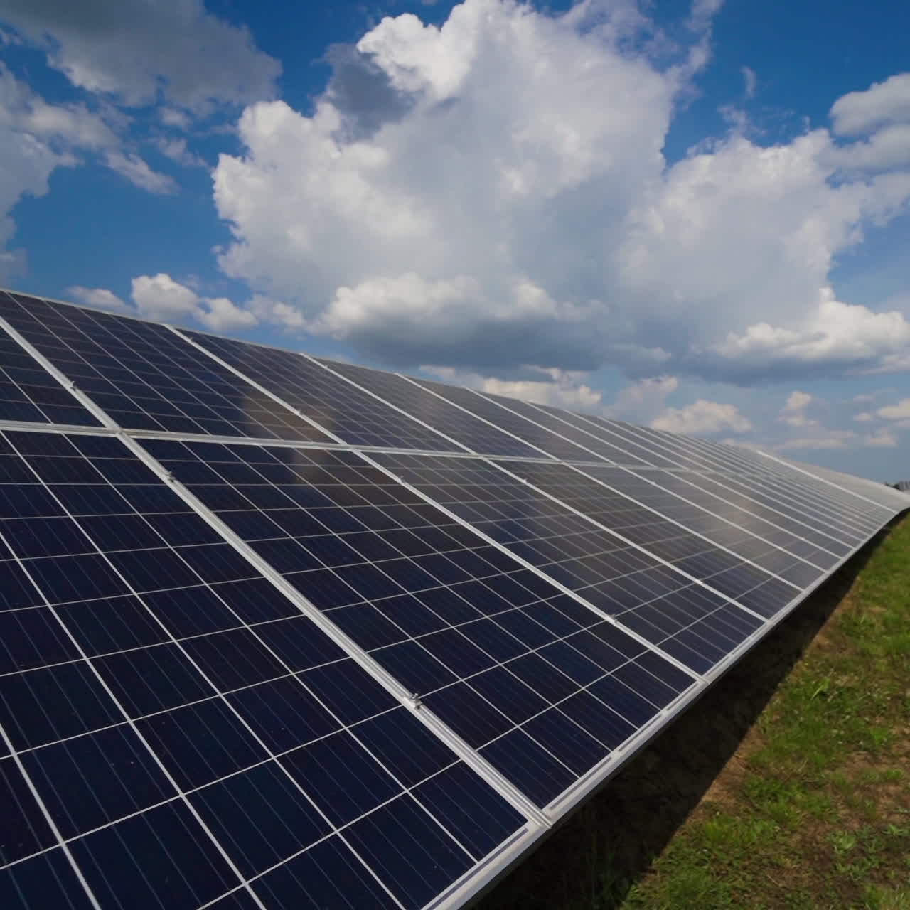 Solar panel on a modern station in a bright day. White clouds over the solar panel. Alternative clean electricity. Innovative technology to create renewable energy on a power plant.