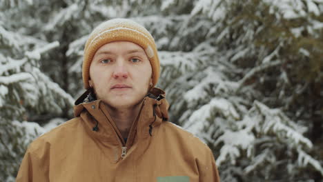 portrait of cheerful man in winter forest