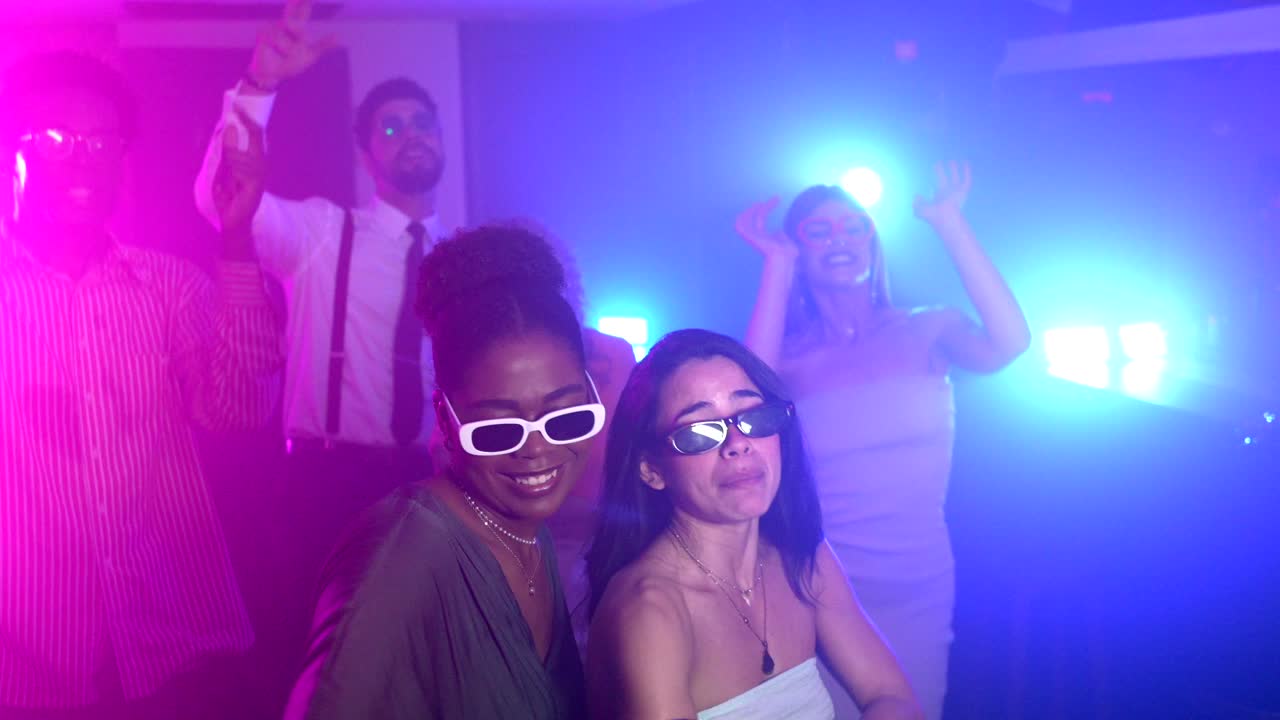 People dancing in a club with neon lights