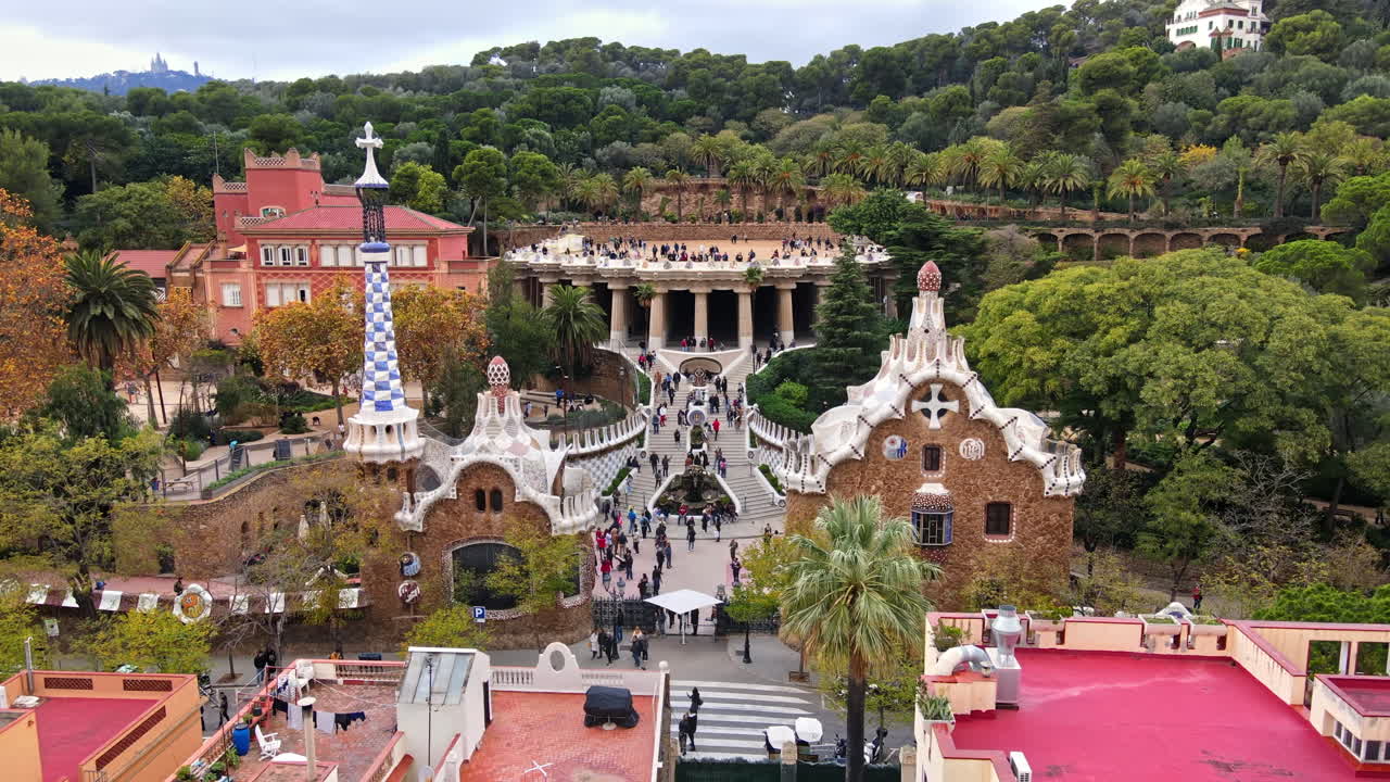 Aerial drone view of Barcelona, Spain. Park Guell with tourists, a lot of greenery
