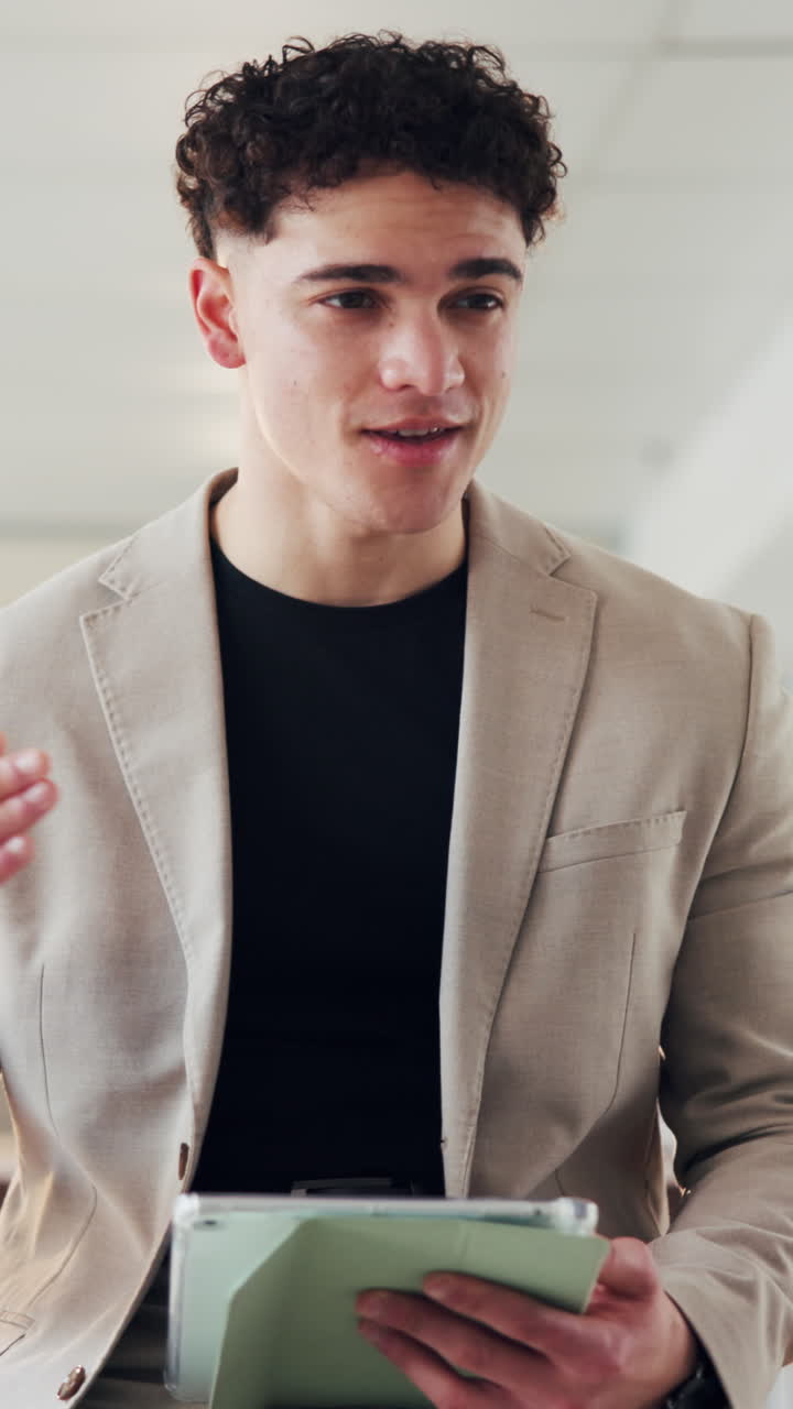 Young Professional Man Talking and Gesturing with Digital Tablet
