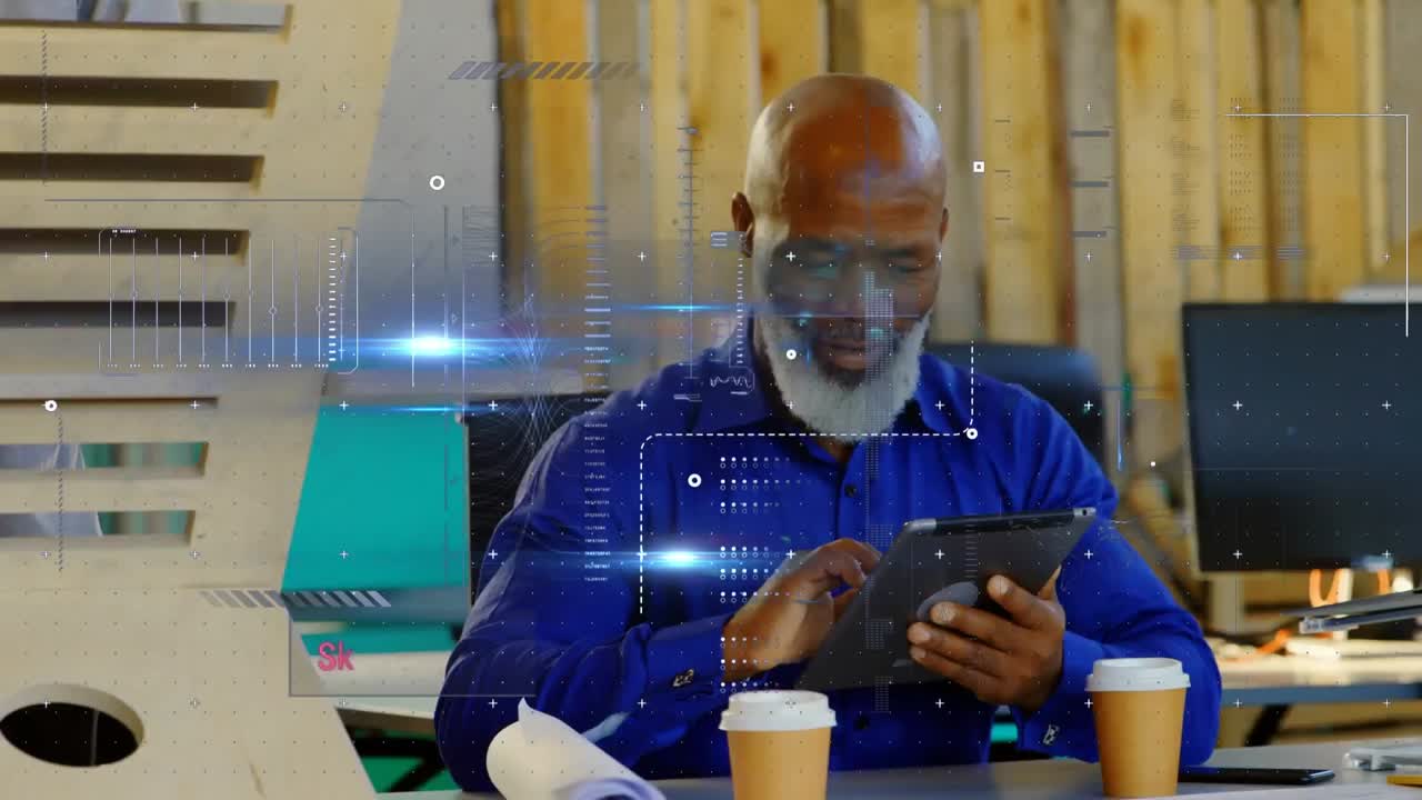 Animation of data processing over african american businessman using digital tablet at office