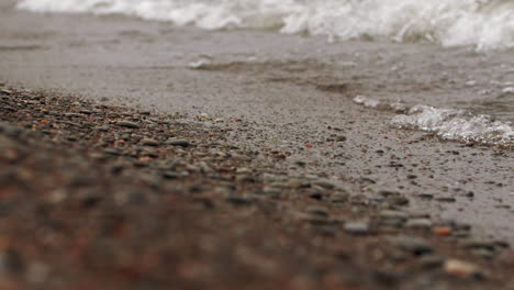 waves in slow motion hitting the rocky shore and crashing with power