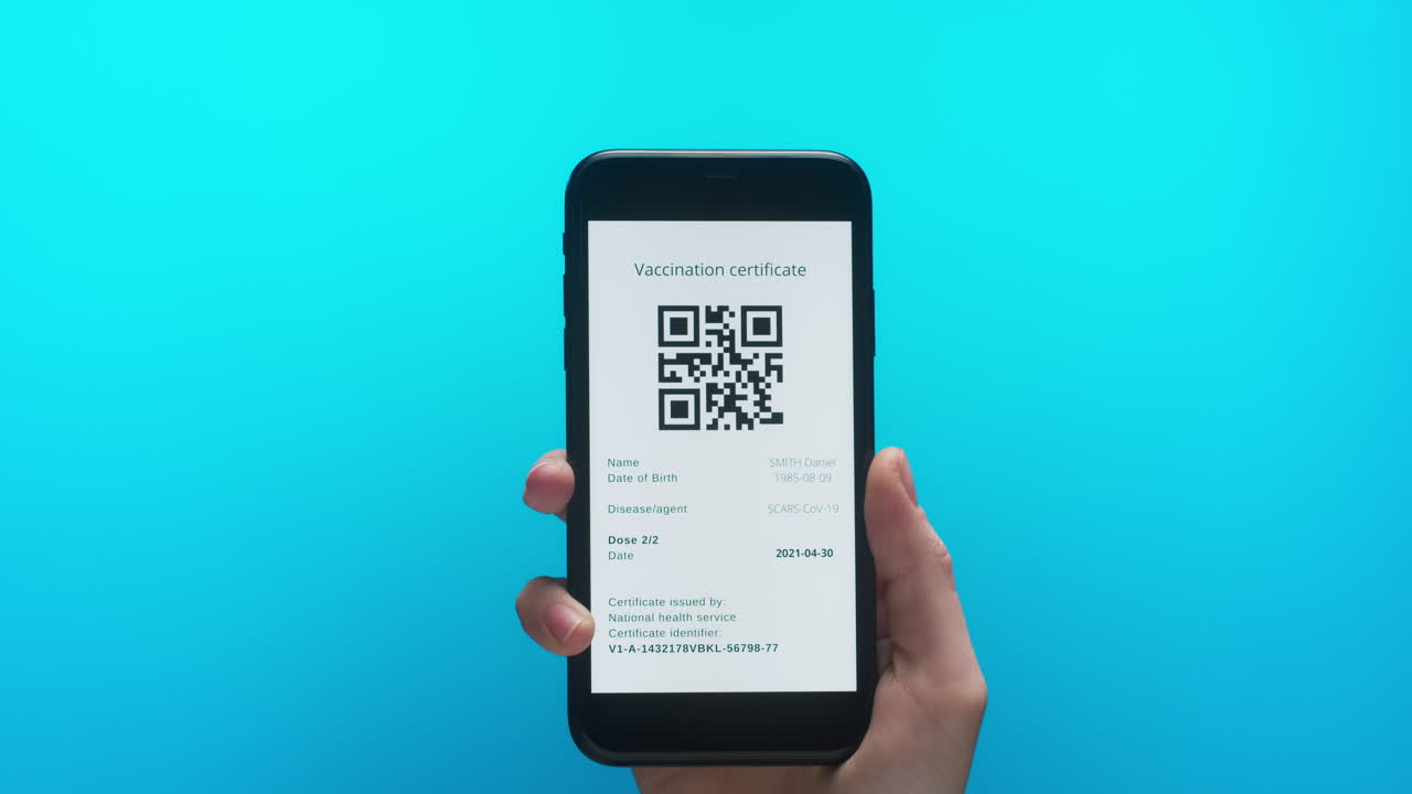 Hand Holding Smartphone Displaying Digital Vaccination Certificate with QR Code