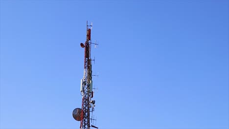 Big-tall-antenna-a-radio-transmitter-full-with-satellite-dishes-emitting-radio-waves