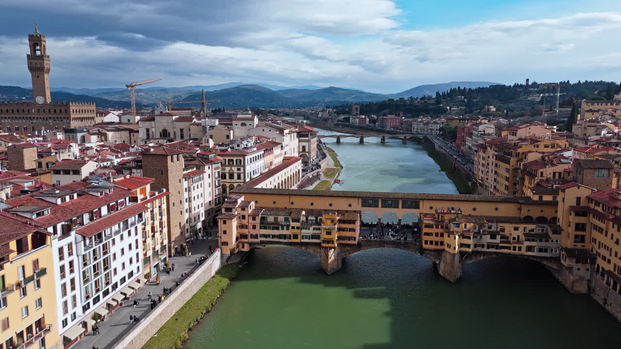 Historic Ponte Vecchio bridge in Florence, Italy, with the Arno River and cityscape