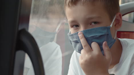 child in mask showing middle finger as revolt