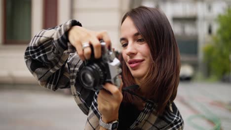 smiling woman photographer taking photos in the city