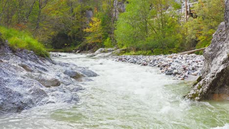 volo ad angolo basso sopra gli spruzzi della cascata d'acqua del fiume