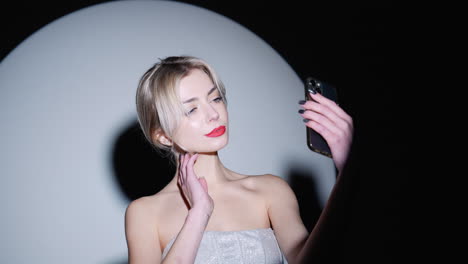 woman taking selfie in studio setting