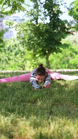 young woman stretching in park